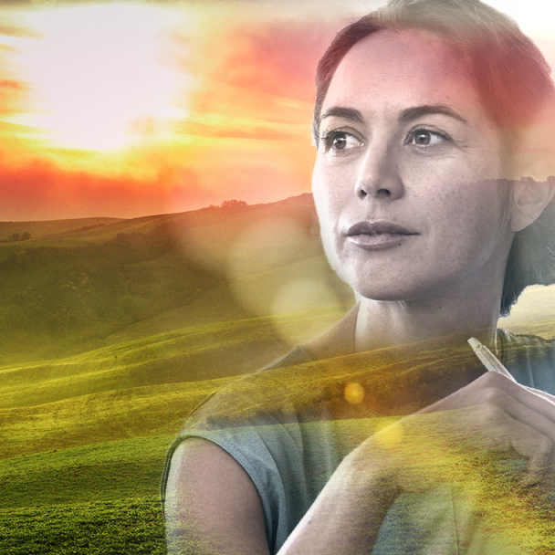 Graphic overlay of a woman looking beyond the camera overlayed with a sunset over a luscious green valley