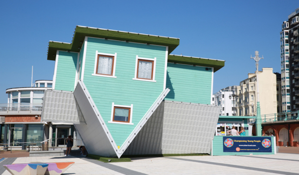 An upside down house art installation on Brighton beach, England