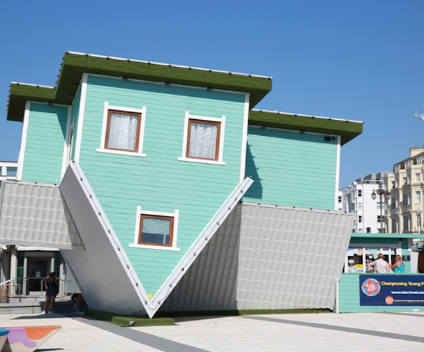An upside down house art installation on Brighton beach, England