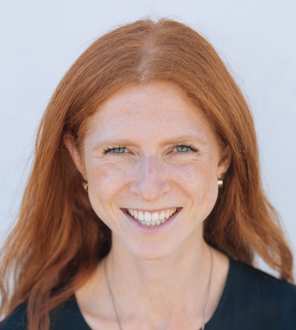Full face profile headshot of a woman smiling at the camera